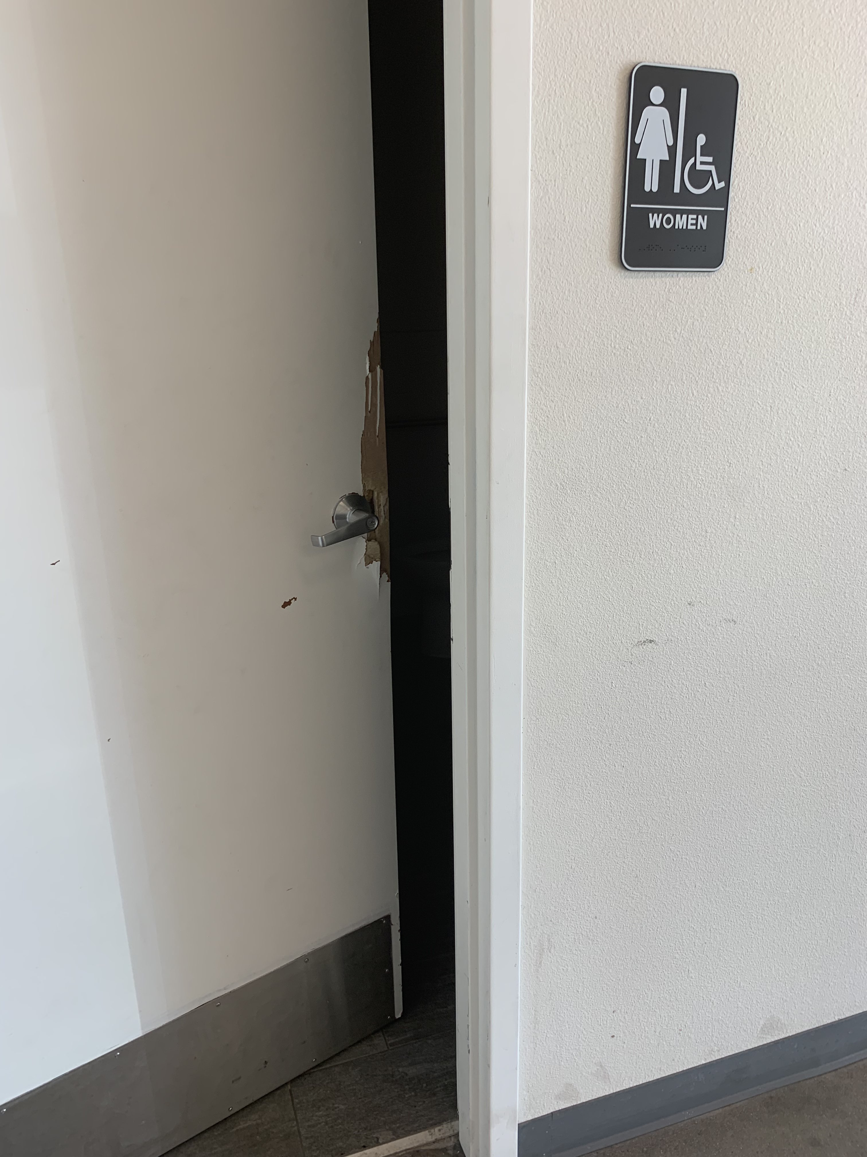 A damaged door to the women's bathroom at the Public Storage facility on 625 Stella Street in Fort Worth, TX